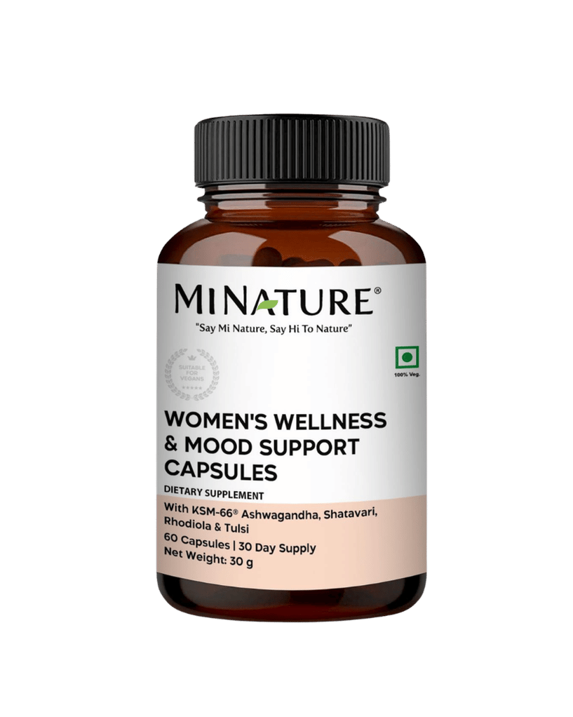 A bottle of Minature Women's Wellness & Mood Support Capsules on a solid dark green background. The product is in an amber brown bottle with a black ribbed cap and a white label featuring black text and a light peach section at the bottom.